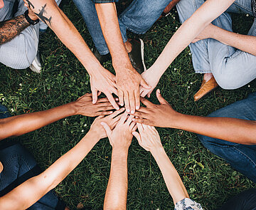 Menschen legen Ihre Hände zusammen 